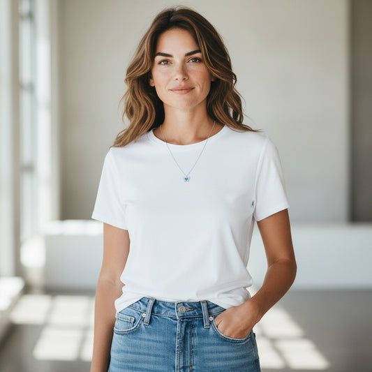 Woman wearing a TITLIYA blue butterfly pendant necklace with a white t-shirt and jeans in a bright indoor setting.