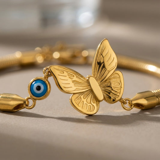 TITLIYA gold-tone boho bracelet featuring a butterfly charm and a blue evil eye bead on a sleek chain.