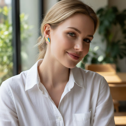 Woman wearing TITLIYA colorful enamel butterfly stud earrings with gold-tone stainless steel trim.