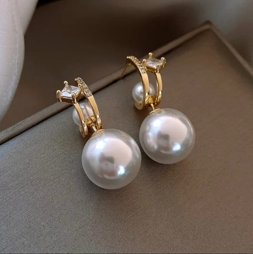 TITLIYA golden 2-way earrings featuring large white pearls and sparkling square-cut cubic zirconia accents.