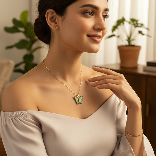 Model wearing a TITLIYA Luna-style alloy butterfly necklace with green and blue enamel details on a gold chain.