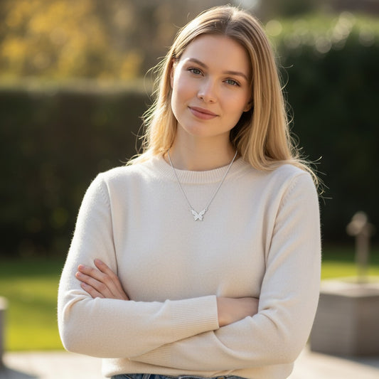 Model wearing a TITLIYA hallmarked stainless steel butterfly necklace with a minimalist design and silver finish.