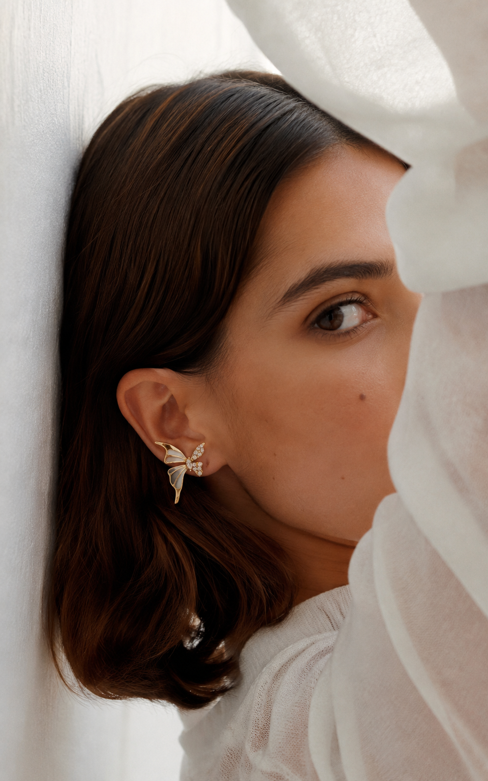 TITLIYA non-piercing butterfly earcuff with sparkling zircon accents worn by a woman in a white off-shoulder top.