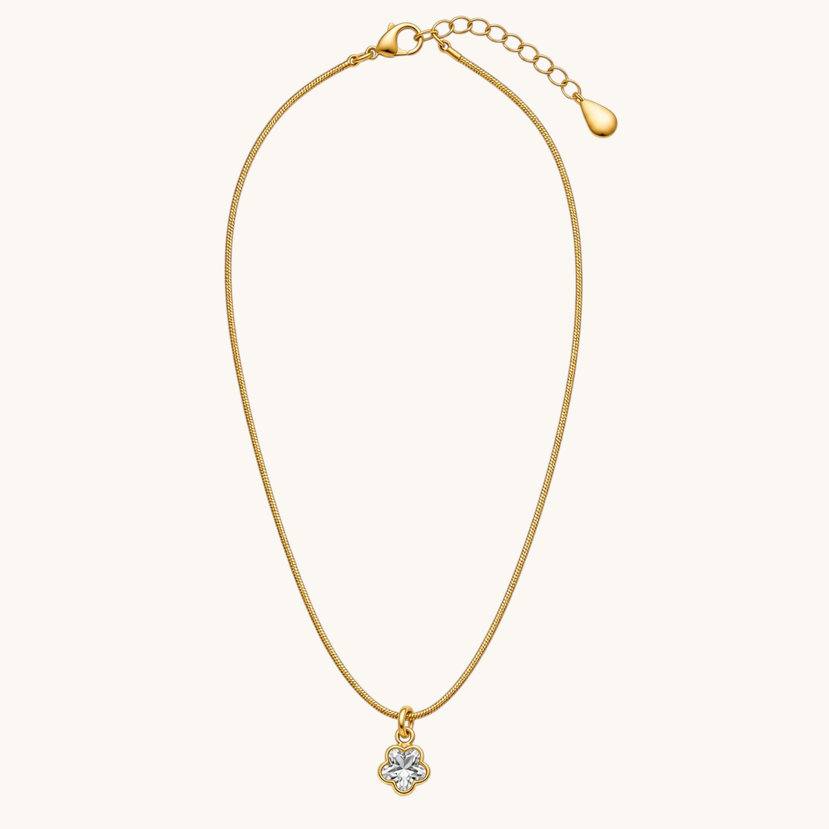 TITLIYA gold-tone fine chain necklace featuring a delicate mini four-leaf clover pendant with clear stone detailing.