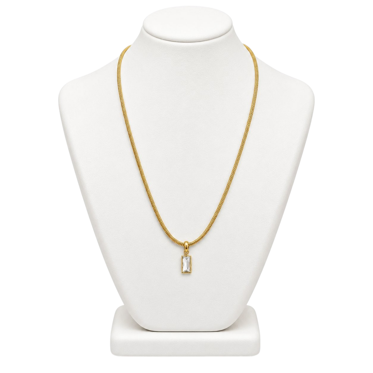 TITLIYA gold-tone fine chain necklace with a mini rectangular pendant featuring a sparkling clear stone on a display.