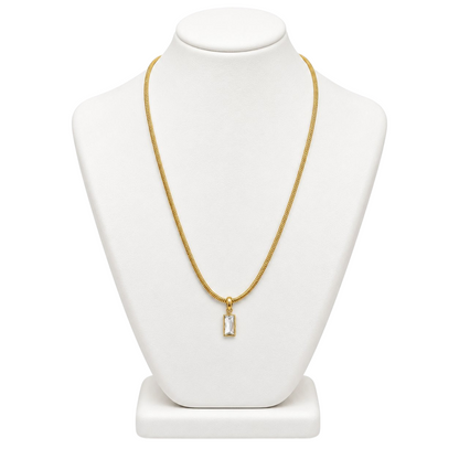 TITLIYA gold-tone fine chain necklace with a mini rectangular pendant featuring a sparkling clear stone on a display.