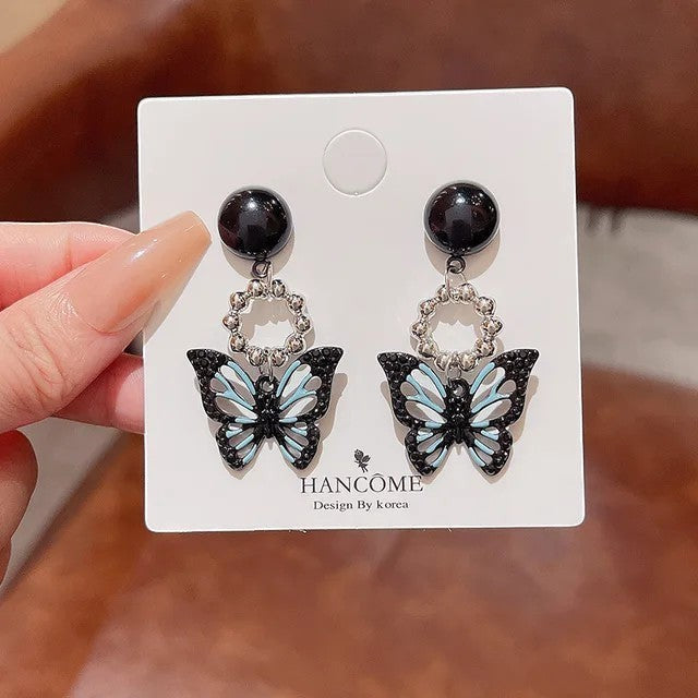 TITLIYA Korean style acrylic butterfly earrings in black and light blue with a glossy finish and silver ring accents.