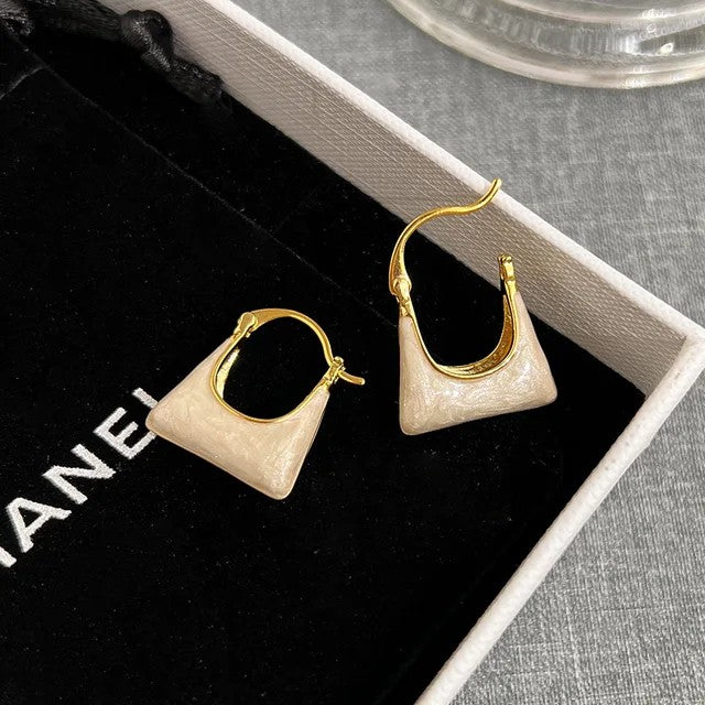 TITLIYA gold-tone hoop earrings with unique cream-colored bag-shaped charms, perfect for elegant daily wear.