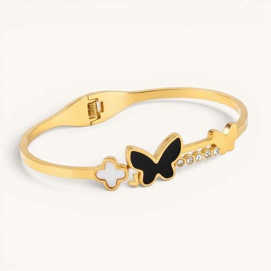 TITLIYA gold-tone bracelet featuring a black butterfly, white floral accent, and crystal embellishments.