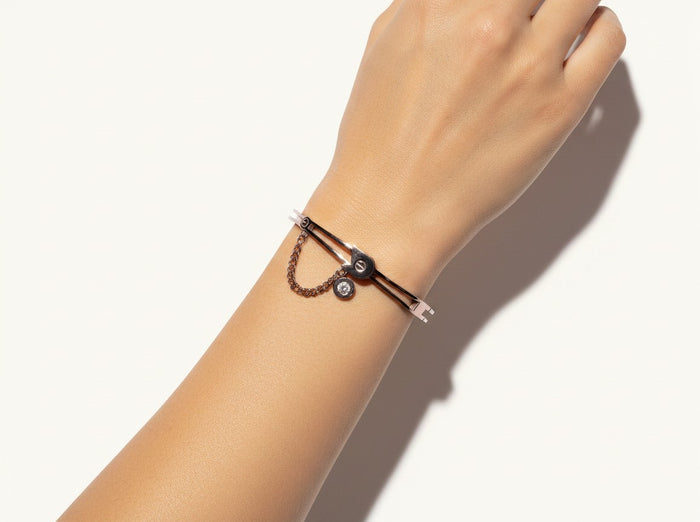 TITLIYA rose gold butterfly bracelet with a delicate chain and crystal charm worn on a woman's wrist.
