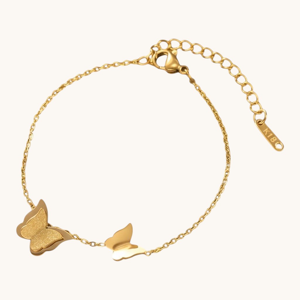 TITLIYA gold-tone link bracelet featuring one textured glitter butterfly charm and one smooth polished butterfly charm.