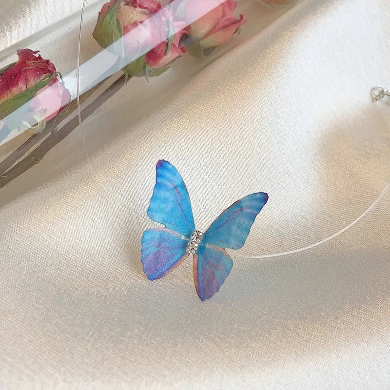 TITLIYA adjustable choker necklace featuring a delicate blue and purple butterfly pendant on a clear nylon cord.