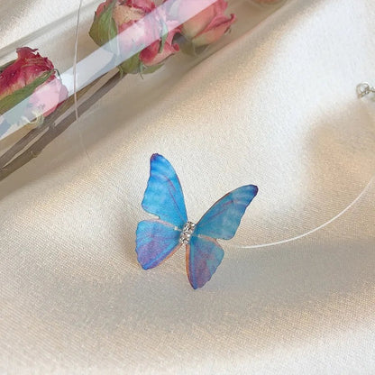 TITLIYA adjustable choker necklace featuring a delicate blue and purple butterfly pendant on a clear nylon cord.