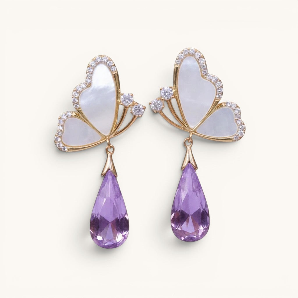 TITLIYA Korean-style butterfly earrings with white mother-of-pearl, gold trim, and dangling purple crystal teardrops.