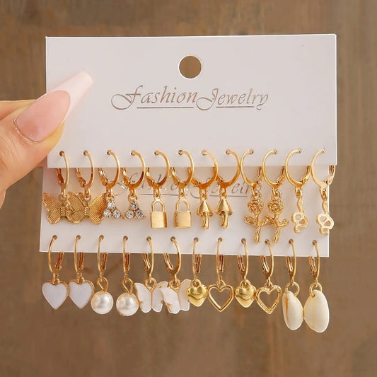 TITLIYA 12-pair gold-tone hoop earring set featuring butterfly, heart, pearl, and floral charms for versatile styling.