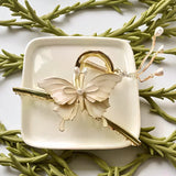 TITLIYA off-white butterfly hair claw clip with gold-tone metal, faux pearls, and dangling chain accents.