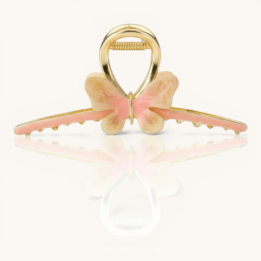 TITLIYA butterfly hair claw in pink and cream enamel with a polished gold finish and non-slip jaw grip.