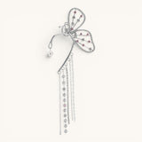TITLIYA butterfly long cuff earring in silver with pink crystals, pearl accents, and dangling chain tassels.
