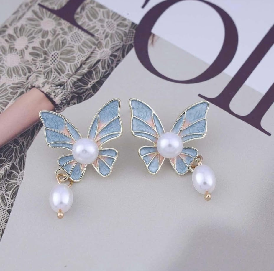 TITLIYA butterfly drop earrings with blue and pink enamel, lustrous pearl centers, and dangling pearl accents.