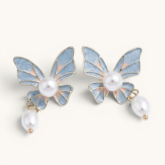 TITLIYA butterfly drop earrings with blue and pink enamel wings, lustrous pearl centers, and dangling pearl accents.