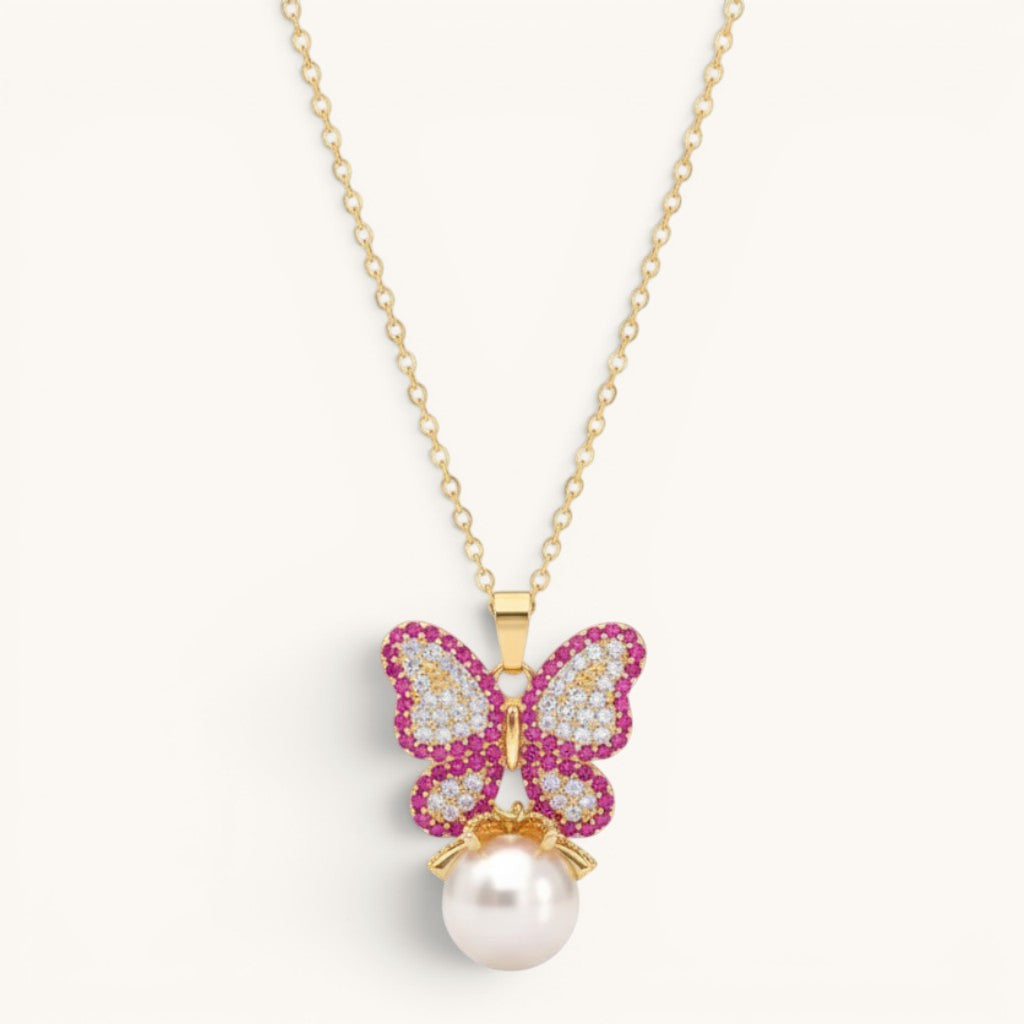 TITLIYA gold-tone alloy butterfly pendant necklace with pink and white crystals and a dangling white pearl charm.