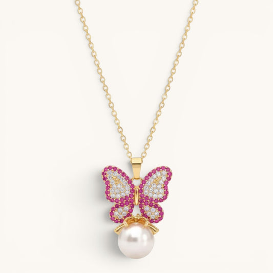 TITLIYA gold-tone alloy butterfly pendant necklace with pink and white crystals and a dangling white pearl charm.