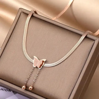 TITLIYA rose gold-toned snake chain necklace with a textured butterfly pendant and two dainty drop bead chains.