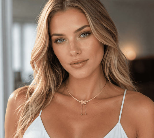 TITLIYA rose gold butterfly pendant necklace with snake chain and drop bead details worn by a blonde model.