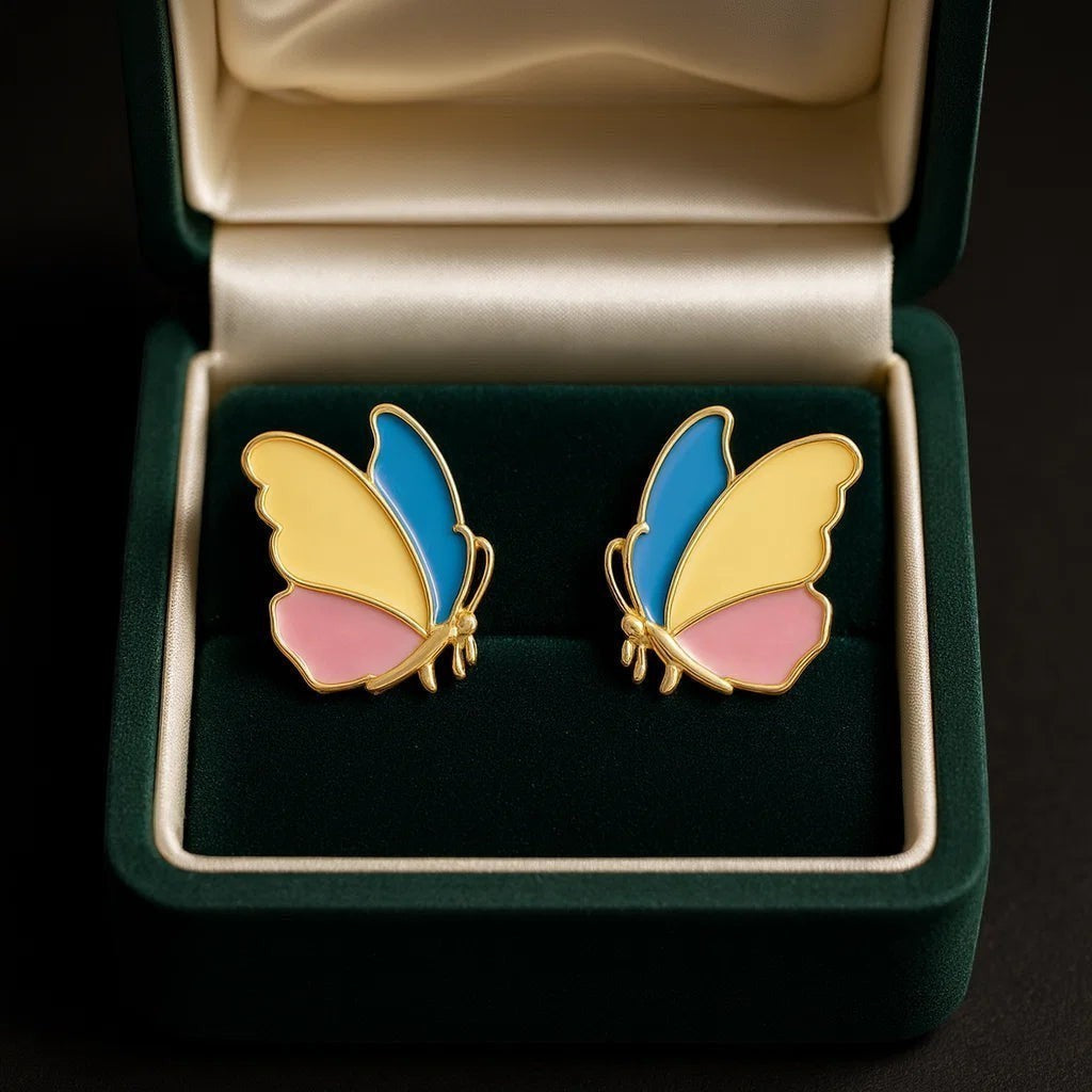 TITLIYA colourful stainless steel butterfly earrings with blue, yellow, and pink enamel in a green velvet jewelry box.
