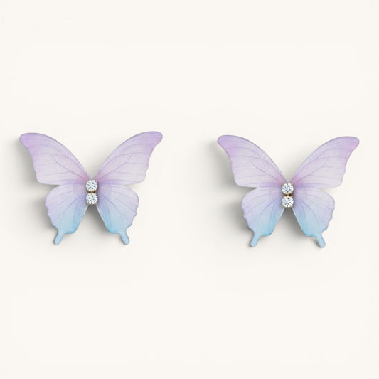 TITLIYA feather-light butterfly stud earrings in pastel purple and blue gradient with sparkling crystal accents.