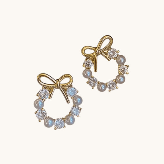 TITLIYA gold-tone circle stud earrings featuring a bow knot design with alternating white pearls and clear crystals.