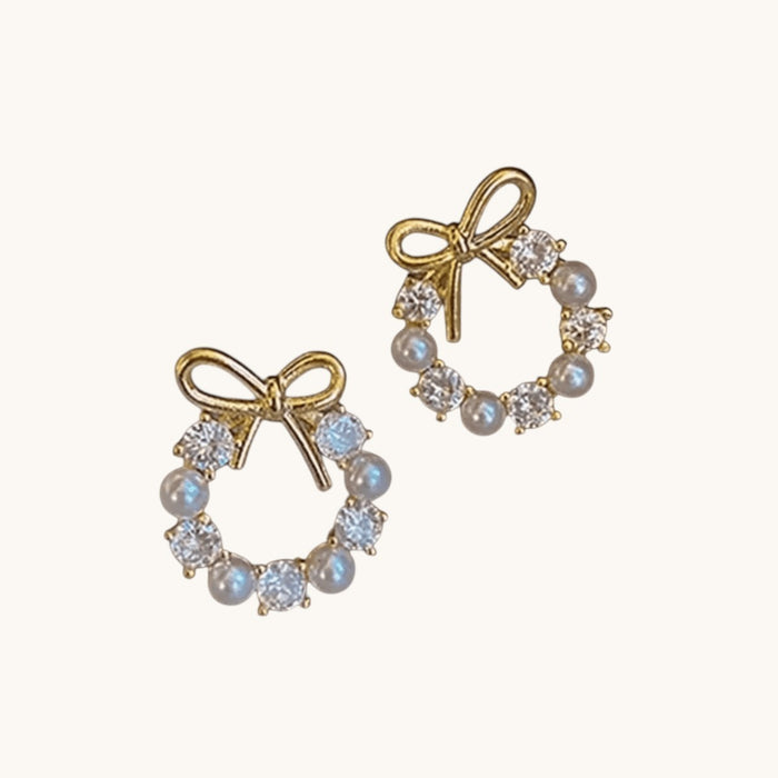 TITLIYA gold-tone circle stud earrings featuring a bow knot design with alternating white pearls and clear crystals.