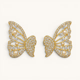 TITLIYA gold-tone butterfly stud earrings featuring sparkling crystals and small white pearls for an elegant look.