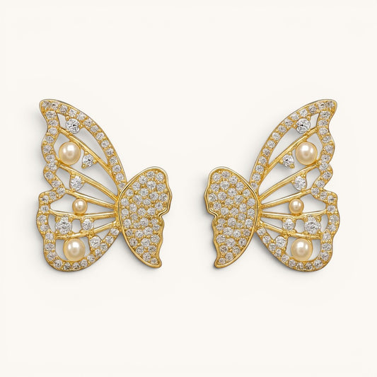 TITLIYA gold-tone butterfly stud earrings featuring sparkling crystals and small white pearls for an elegant look.