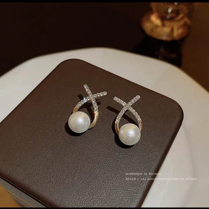 TITLIYA diamond studded cross earrings featuring a lustrous white pearl, elegant gold-tone design for daily wear.