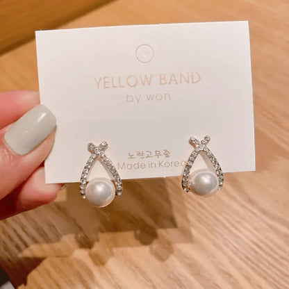 TITLIYA double cross stud earrings featuring sparkling crystals and a central white pearl for elegant daily wear.