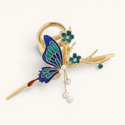 TITLIYA gold-tone butterfly hair clip with blue and green enamel, floral accents, and dangling pearl charms.