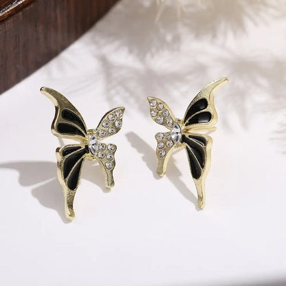 TITLIYA Enchanted Stud Butterfly Earrings in gold alloy with black enamel and sparkling crystal stone accents.