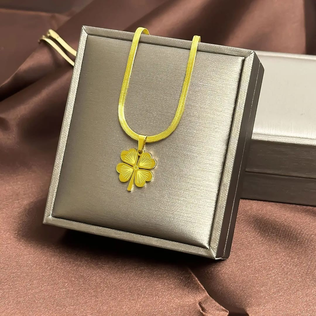 TITLIYA gold-tone flower clover pendant necklace with a sleek herringbone chain on a display box.
