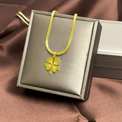 TITLIYA gold-tone flower clover pendant necklace with a sleek herringbone chain on a display box.