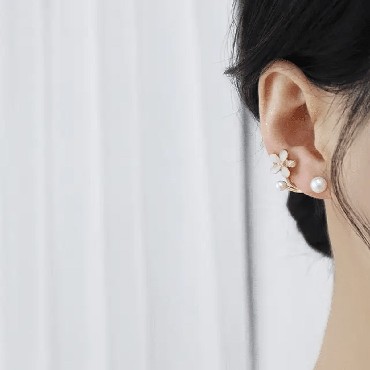 TITLIYA elegant Korean-style flower earring with a crystal leaf and pearl accent worn on a woman's ear.