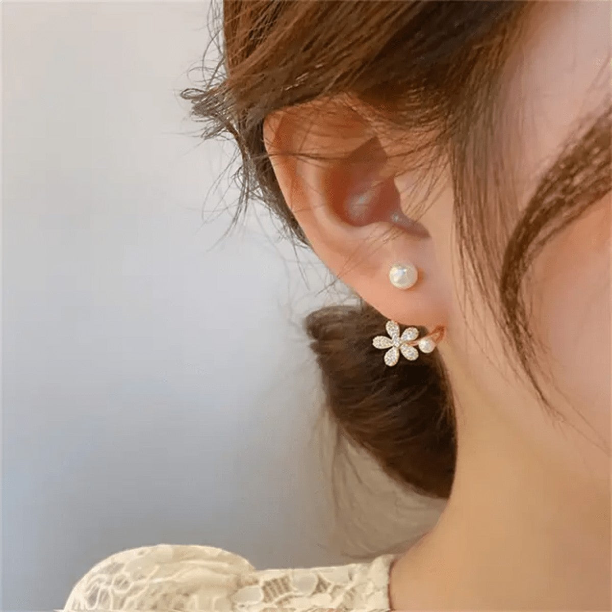 TITLIYA Korean-style flower earrings with sparkling crystals and pearl accents worn by a woman for elegant daily wear.