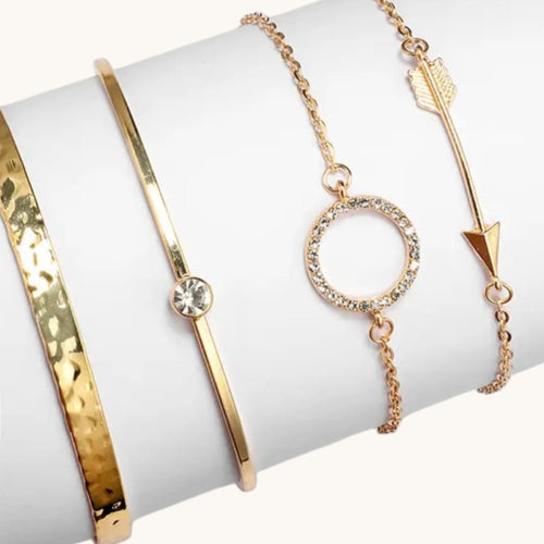 TITLIYA set of four gold-tone bracelets featuring a hammered cuff, crystal accent, circle charm, and arrow design.