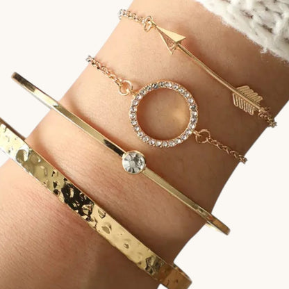 TITLIYA set of four gold-tone bracelets featuring an arrow, crystal circle, solitaire, and hammered cuff design.