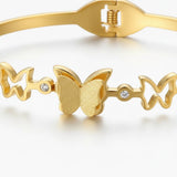 TITLIYA gold-tone bracelet featuring multiple butterfly motifs and sparkling crystal accents for festive wear.