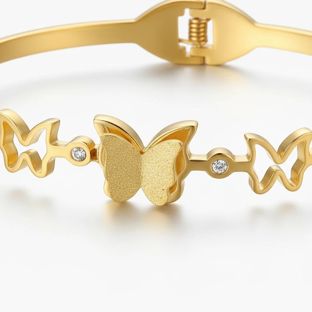 TITLIYA gold-tone bracelet featuring multiple butterfly motifs and sparkling crystal accents for festive wear.