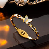 TITLIYA gold-plated butterfly bracelet with pearlescent center and crystal accents on a polished chain-link band.