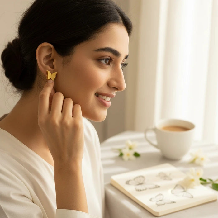 Woman wearing elegant gold butterfly earrings by TITLIYA, perfect for daily wear or gifting.