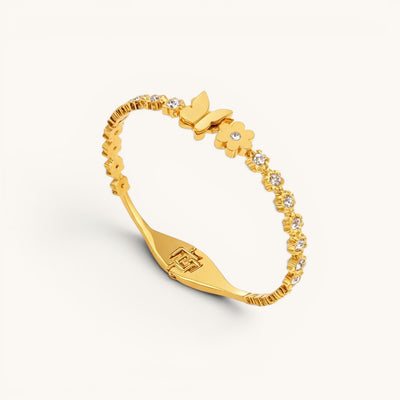 TITLIYA gold-plated bracelet with butterfly and flower motifs, featuring sparkling crystal accents on a slim band.