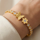 TITLIYA gold-plated bracelet featuring a butterfly and flower motif with sparkling crystal accents on a wrist.
